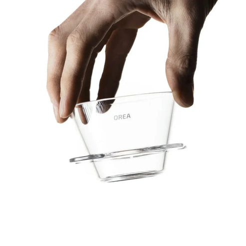 Person holding the Orea V1 brewer in their hand.