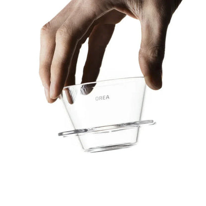 Person holding the Orea V1 brewer in their hand.