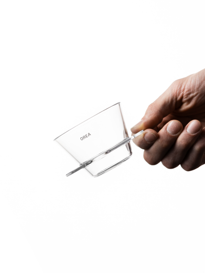 Close-up of a thumb holding the Orea V1 brewer.