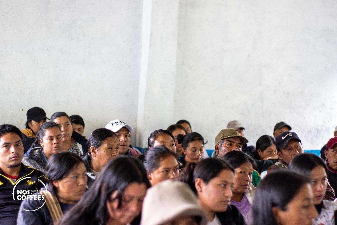 A room filled with attentive indigenous community members and smallholder farmers in Nariño, Colombia. Their focused expressions highlight the cooperative, shared knowledge and collective effort that goes into harvesting and processing the washed Castillo beans for Somewhere Coffee's Nariño Reserve.