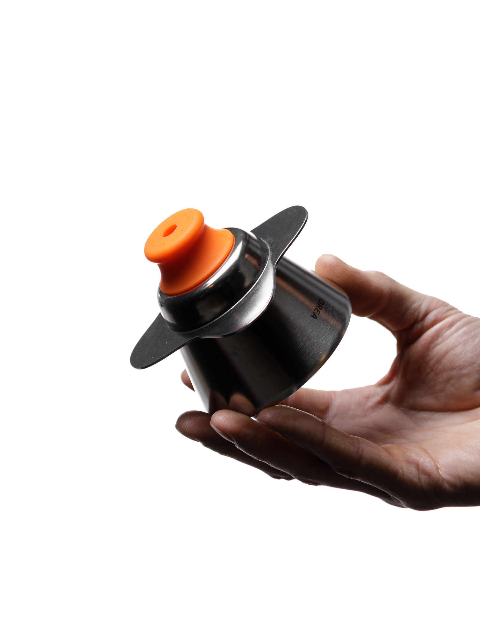A hand cradling the fully assembled OREA O2 Darth Black Brewer fitted with the bright orange #8 Fast Regulator, contrasting the deep black Tritan plastic with the vivid silicone flow-control piece.