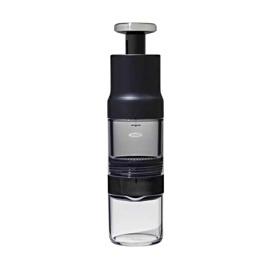 A clean, high-resolution studio shot of the fully assembled OXO Brew Rapid Brewer featuring its sleek black, clear, and stainless steel design, ready to brew rich, concentrated coffee from Somewhere Coffee's Colombian single-origin beans.