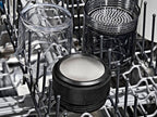 Clear and black components of the OXO Brew Rapid Brewer sitting neatly in a dishwasher rack, highlighting the easy cleaning and dishwasher-safe design of the stainless steel filter and Tritan carafe.