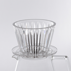 Detailed close-up of the Timemore Crystal Eye B75 dripper, showcasing the precision-molded plastic finish and the distinctive crystal eye pattern on the exterior.